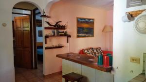 a living room with a red couch and a counter at Pacific Jungle Condominium in Playa Hermosa +75 photos