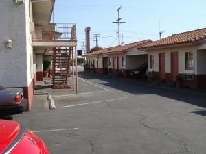 a building that has a fire hydrant on the side of it at American Inn in South El Monte
