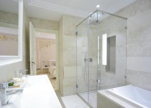 a bathroom with a shower and a sink and a tub at Dar Corniche La Marsa (Adults Only) in La Marsa