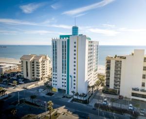 a tall white building with the ocean in the background at Seaside Resort in Myrtle Beach
