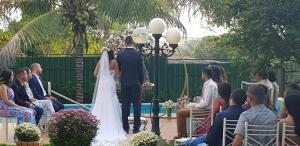 a bride and groom walking down the aisle at their wedding at Hotel das Palmeiras in Paracatu +120 photos