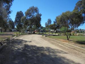 a road that has a lot of trees on it at Yarrawonga Riverlands Tourist Park in Yarrawonga