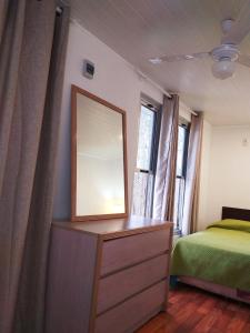 a bedroom with a mirror on a dresser and a bed at Complejo Costa Serena-Casas del Mar in La Paloma
