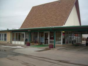 a building with a brown roof on a street at 83 motel in North Platte