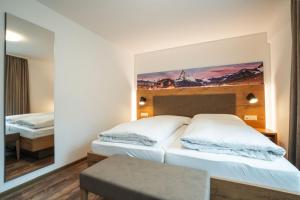 
a hotel room with a bed and a tv at Residence Patricia in Zermatt
