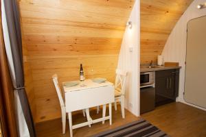 a small kitchen with a table and chairs in a room at Evelix Pods Dornoch in Dornoch