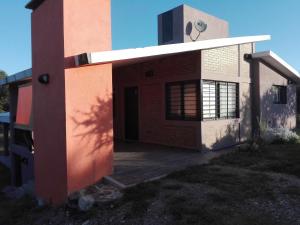 una casa con una puerta abierta a un lado. en Casas de Sierras Da Car en Santa Rosa de Calamuchita