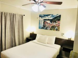 a bedroom with two beds and a ceiling fan at El Dorado Motel in Twain Harte +94 photos