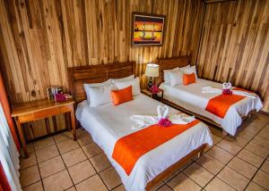 a bedroom with two beds with bows on them at Mar Inn Costa Rica in Monteverde Costa Rica