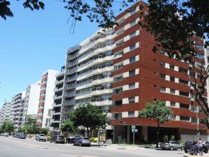 a tall building with cars parked in front of it at Excelente apartamento ubicado en el corazón de pocitos in Montevideo