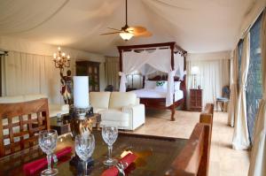 a bedroom with a bed and a table with wine glasses at Clouds Serenity in Beechmont