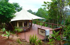 a house with a tent on a wooden deck at Clouds Serenity in Beechmont