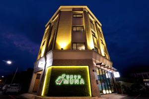 a building with a muna sign on it at night at MUNA Hostel in Hualien City