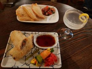 a wooden table with two plates of food on it at Chill Madarao in Iiyama