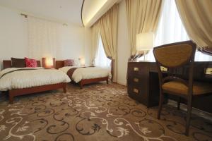 Postelja oz. postelje v sobi nastanitve Hotel Grand Vert Gizan