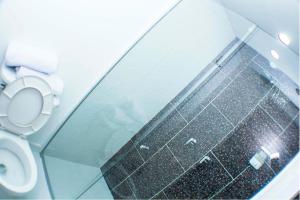 a bathroom with a toilet and a glass wall at Element Hotel in Medellín