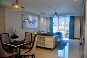 a living room with a couch and a table at Gulf Executive Hotel & Residence Juffair in Manama