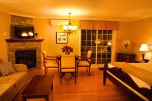 a living room with a table and a fireplace at St-Sauveur Lovely Studio in Piedmont