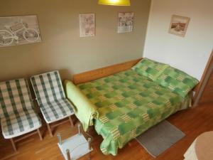 a bedroom with a bed and two chairs at Apartment studio Mia-beach in Split in Split
