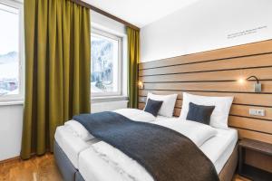 a hotel room with two beds in a room at JUFA Hotel Schladming in Schladming