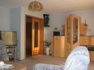 a living room with a couch and a tv at Ferienwohnung Klement in Neubukow