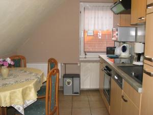 a small kitchen with a table and a table and a table and a tableablish at Ferienwohnung Klement in Neubukow