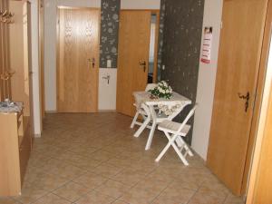 a dining room with a table and two chairs at Ferienwohnung Klement in Neubukow