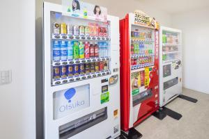 two soda machines in a store with drinks at Hotel Mystays Nayoro in Nayoro
