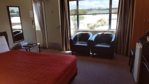 Ένα ή περισσότερα κρεβάτια σε δωμάτιο στο Palm Court Motel