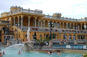 people in the fountain in front of a large building at Little Americas Parliament Apts in Budapest