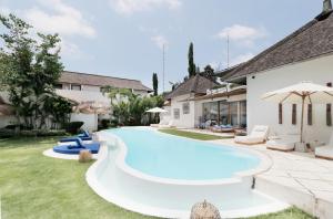a swimming pool in the backyard of a house at The Apartments Umalas in Canggu