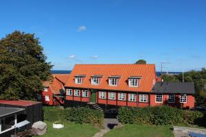 a house with an orange roof at Pension Sandbogaard in Sandvig