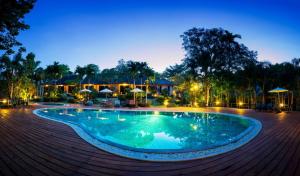 a pool at a resort at night at Lilawalai Resort in Nong Nam Daeng