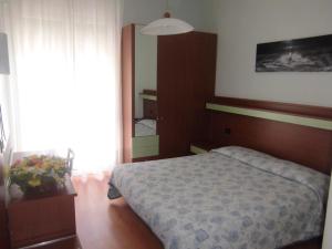 Postel nebo postele na pokoji v ubytování Hotel Palm Beach