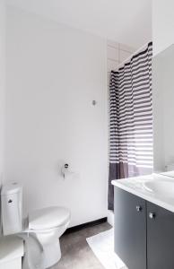 a white bathroom with a toilet and a sink at Student Factory Bordeaux Armagnac in Bordeaux