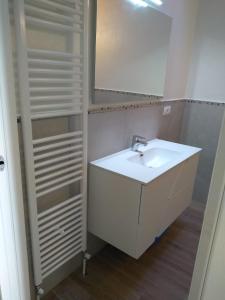 a bathroom with a white sink and a mirror at "Country House il Brolo" in Polpenazze del Garda