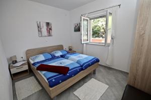 Postel nebo postele na pokoji v ubytování Apartmani Vuljan