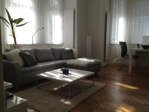 a living room with a couch and a coffee table at Design Apartment Schönbrunn in Vienna