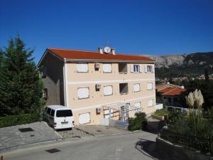 a white van parked in front of a building at Apartments Mikulan Nara in Baška