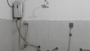 a shower in a bathroom with a wall at Masha Beach Inn in Tangalle