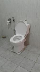 a bathroom with a white toilet in a stall at Masha Beach Inn in Tangalle