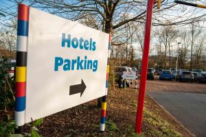 a sign for a parking lot with an arrow at LEGOLAND(R) Windsor Resort in Windsor