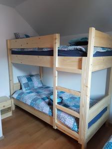two bunk beds in a room with blue sheets at Apartma Katja in Mojstrana