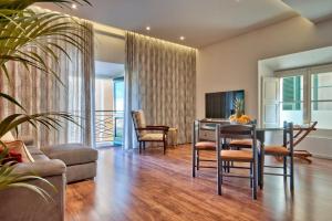 a living room with a table and chairs and a couch at U Collection - a Luxury Collection Suites, Valletta in Valletta