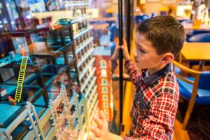 a young boy looking at a toy display in a store at LEGOLAND(R) Windsor Resort in Windsor