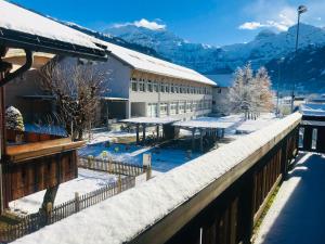 a resort with snow covered mountains in the background at Luna Elk Home in Lenk