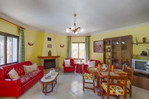 a living room with a red couch and a table at Villas Guzman - Antonio in Calpe