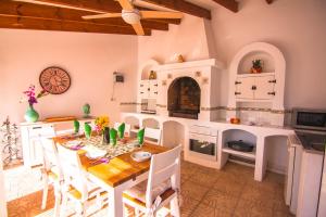 a kitchen with a table and chairs in a room at Villas Guzman - Belvic in Calpe