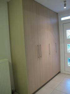 a room with wooden cabinets and a window at Muses Studios Sami in Sami