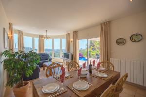 a dining room with a table and chairs and a living room at Villas Guzman - Carlos in Calpe